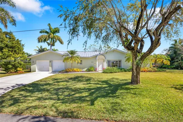 a house that has a tree in front of the house