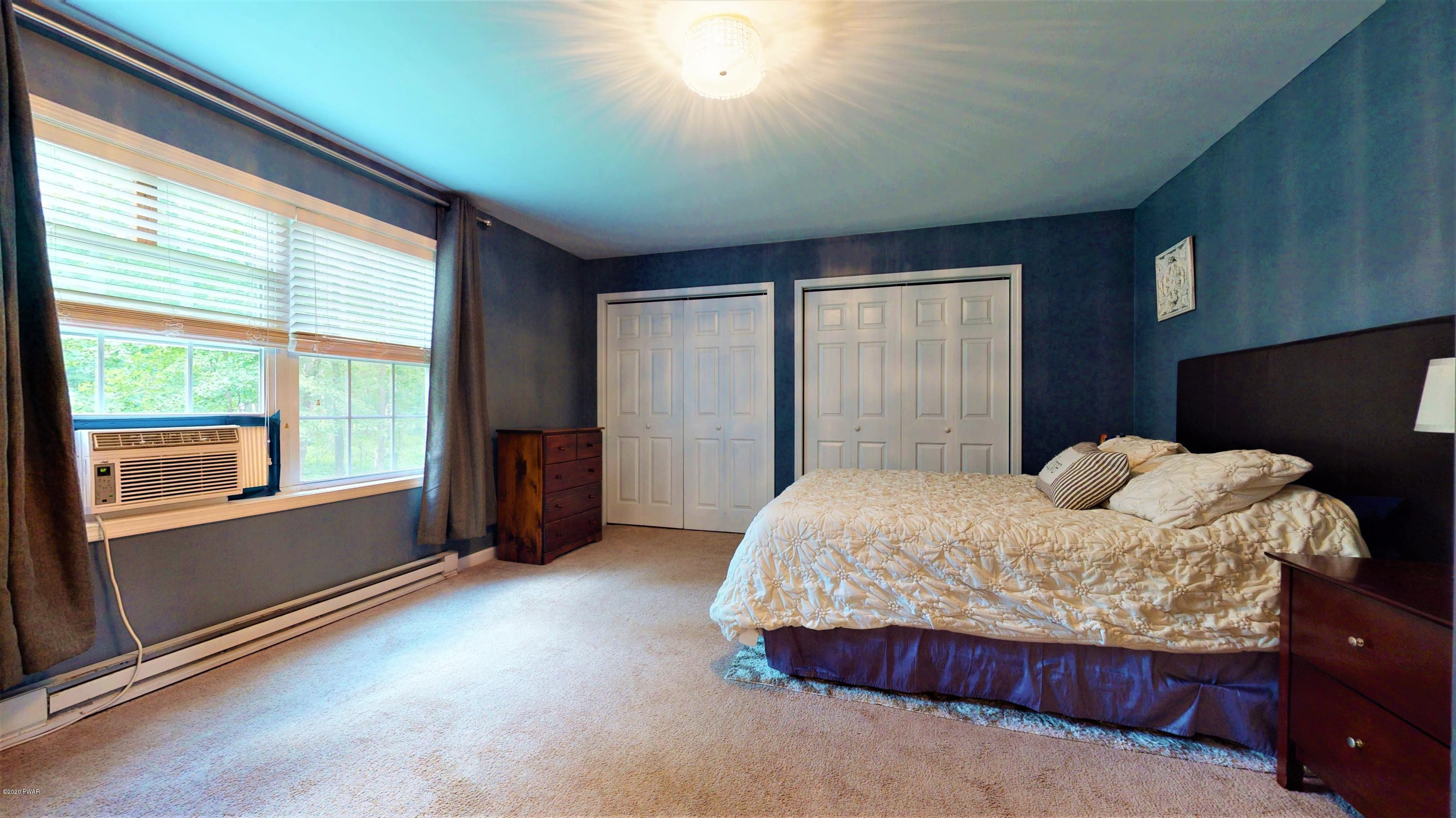 143 Raccoon Road Dingmans Ferry, PA 18328 - Photo 60 of 87 a bedroom with a bed and a large window