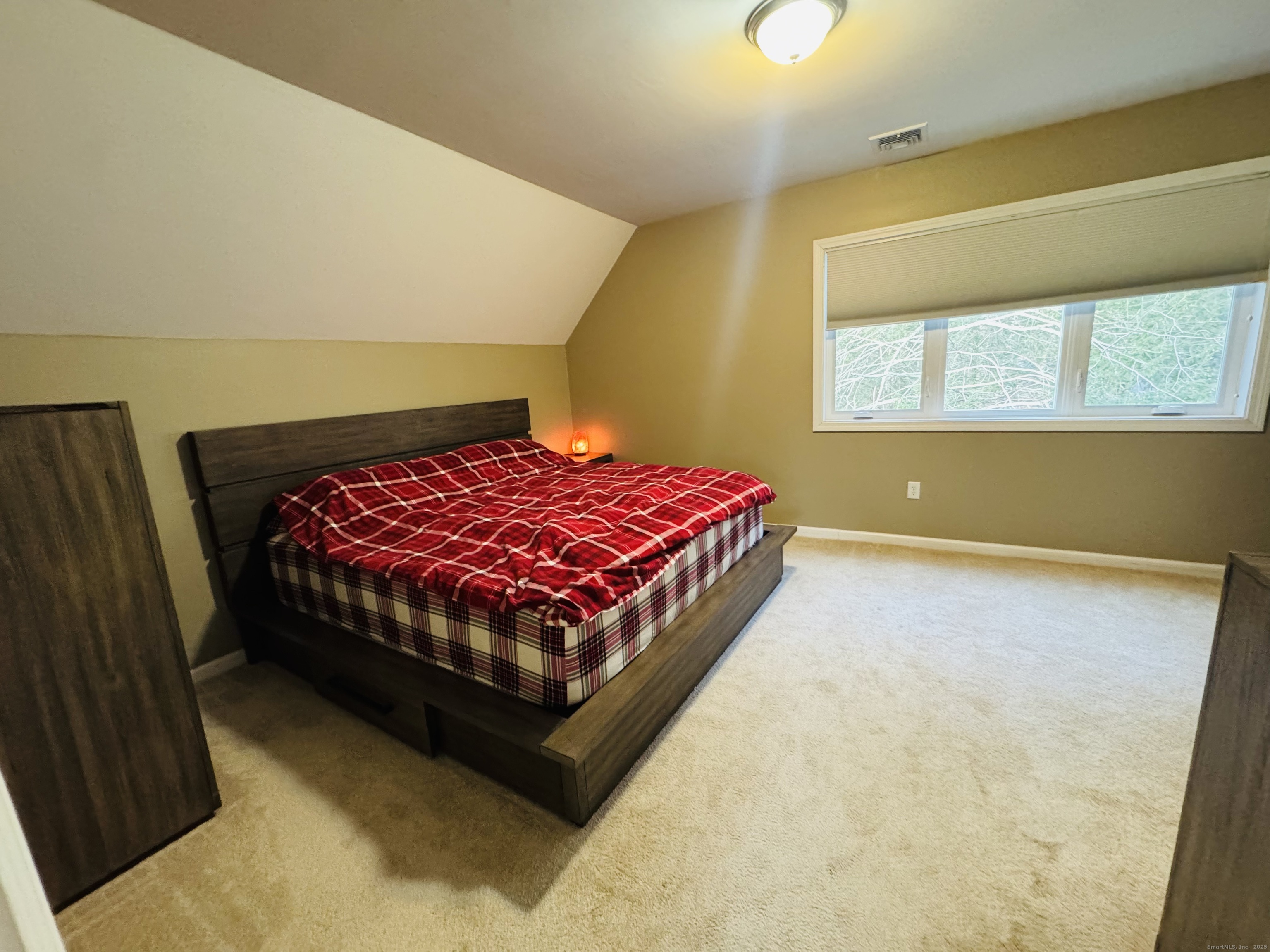 123 Ashford Road, Unit 1 Eastford, CT 06242 - Photo 14 of 24 a bed sitting in a bedroom next to a window