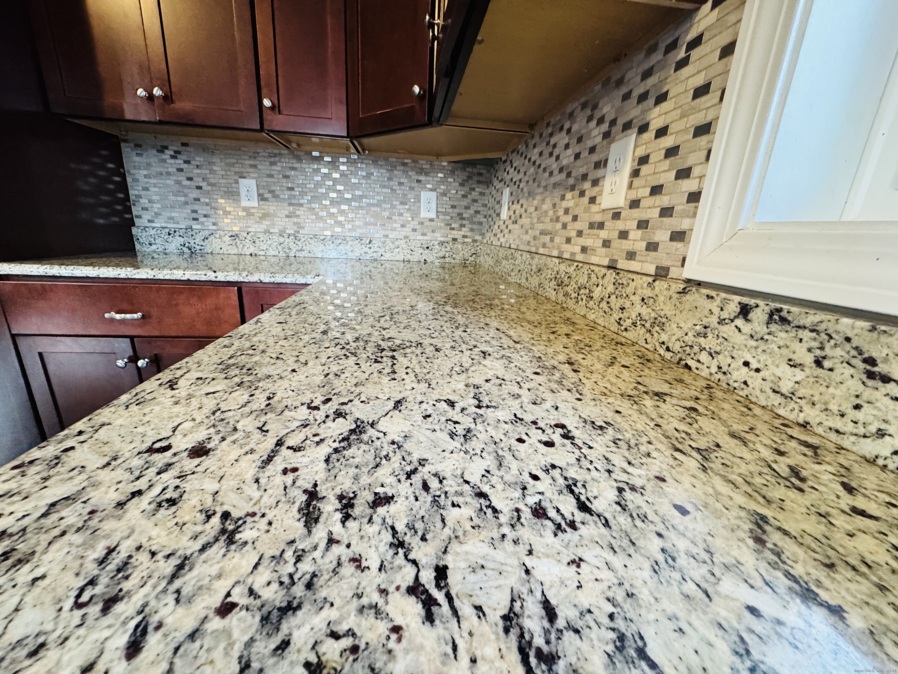 123 Ashford Road, Unit 1 Eastford, CT 06242 - Photo 4 of 24 a kitchen with granite countertop white cabinets and wooden floor