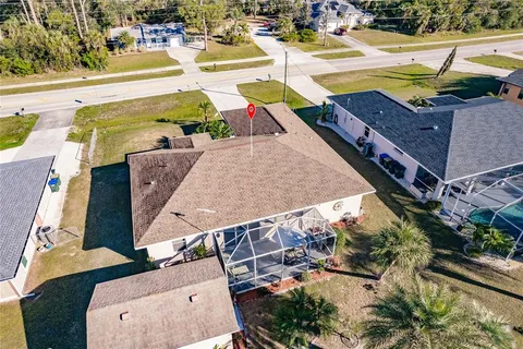 an aerial view of a house with a swimming pool
