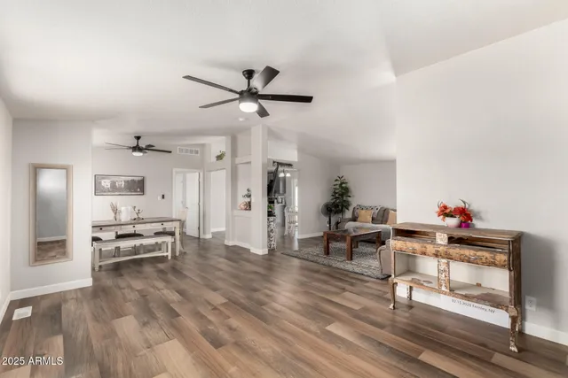 a living room with furniture and a wooden floor