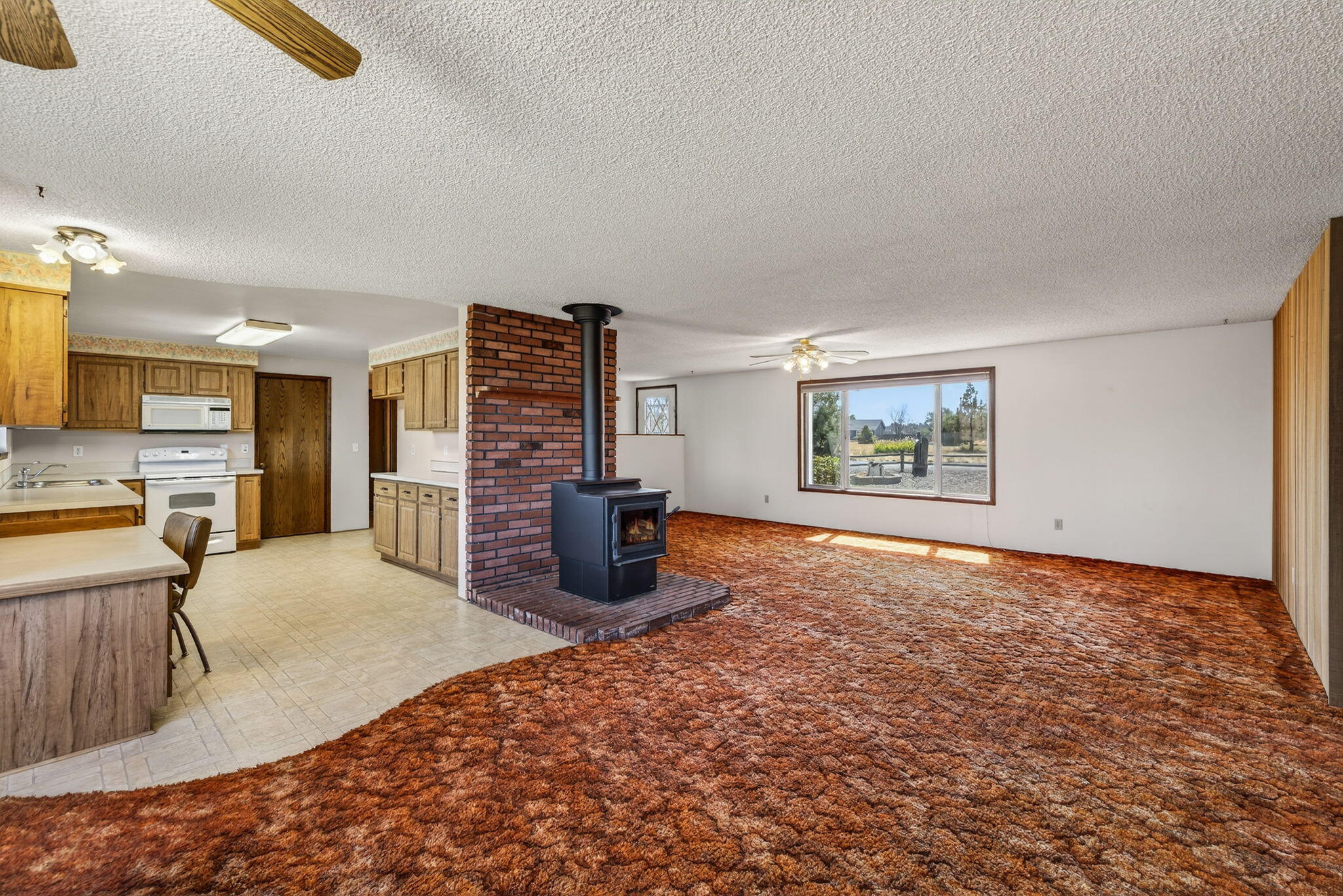 951 Southeast Rancho Lane Madras, OR 97741 - Photo 7 of 48 Dining Area/Living Room w/ Wood Stove