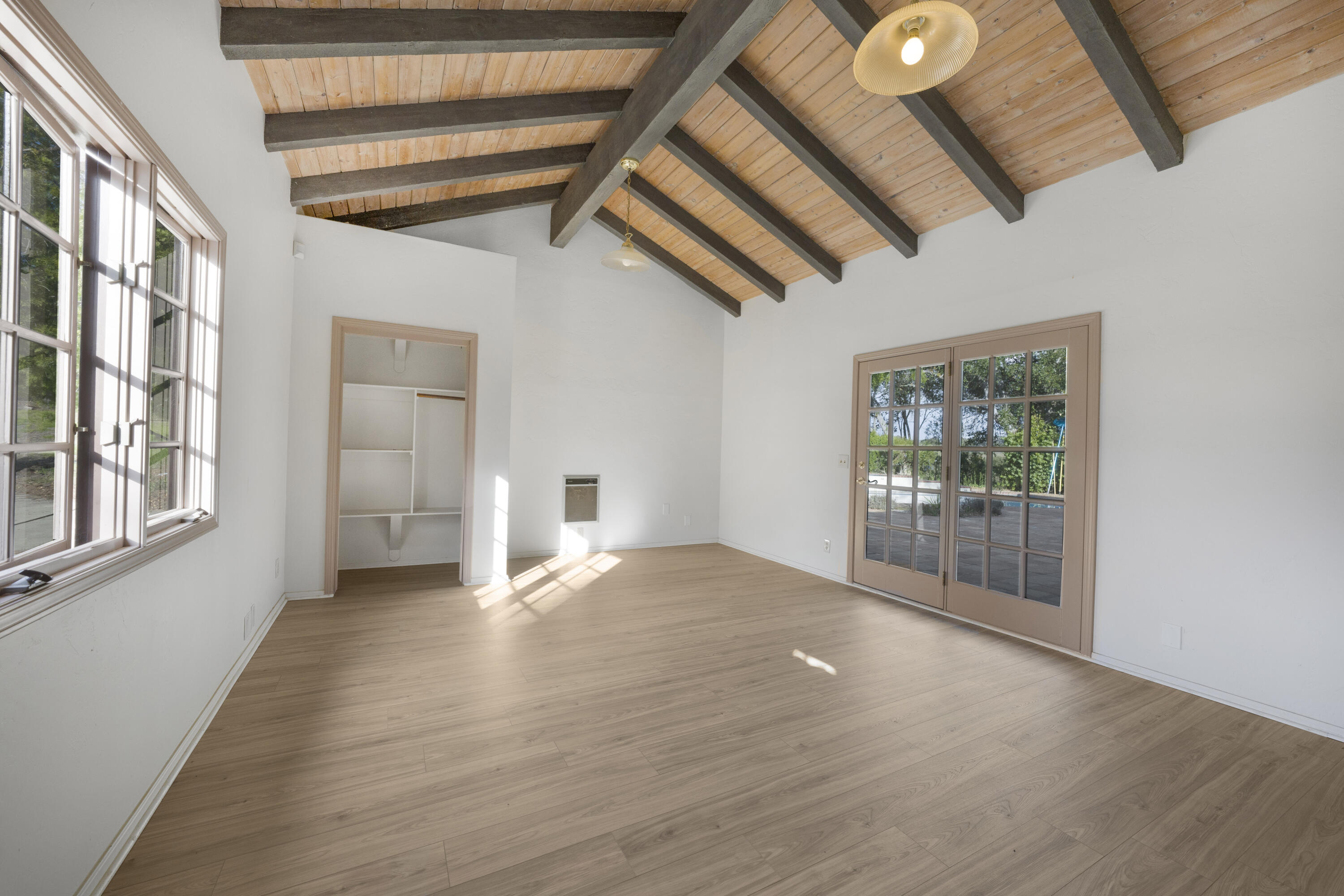 1225 Poppy Valley Road Buellton, CA 93427 - Photo 21 of 42 a view of an empty room with wooden floor and a window