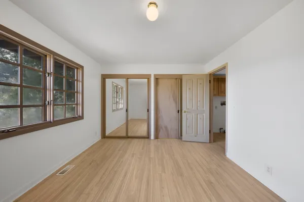 wooden floor in an empty room with a window
