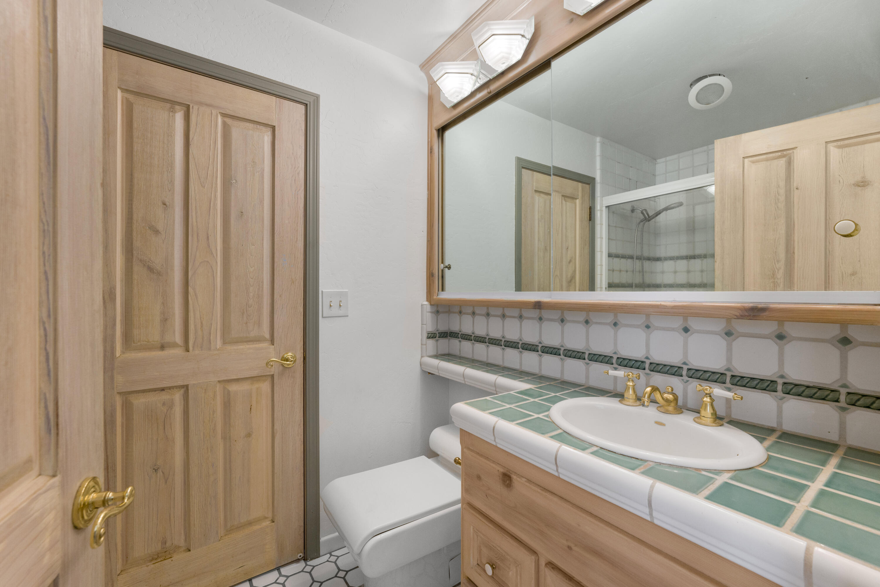 1225 Poppy Valley Road Buellton, CA 93427 - Photo 25 of 42 a bathroom with a granite countertop sink and a mirror with toilet