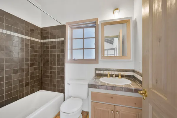 a bathroom with a sink toilet vanity and bathtub