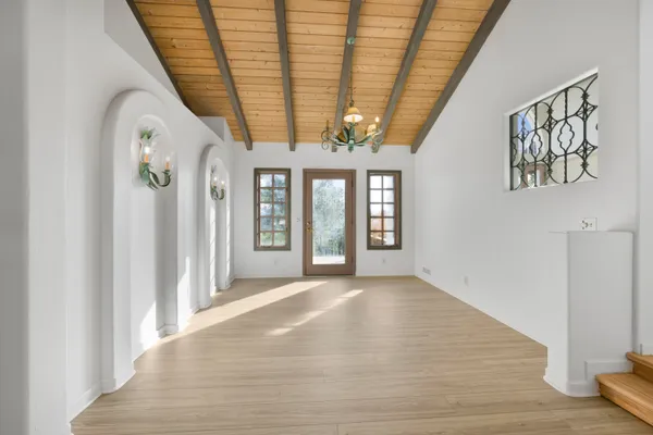 a view of a room with wooden floor and windows