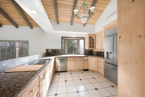 a kitchen with a stove a sink dishwasher and a refrigerator