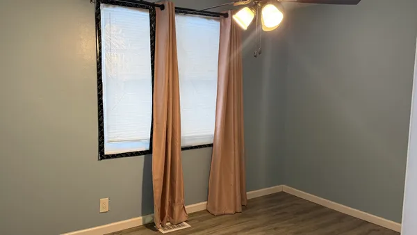 a view of a livingroom with wooden floor and door