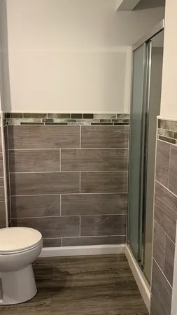 a bathroom with a toilet and a shower