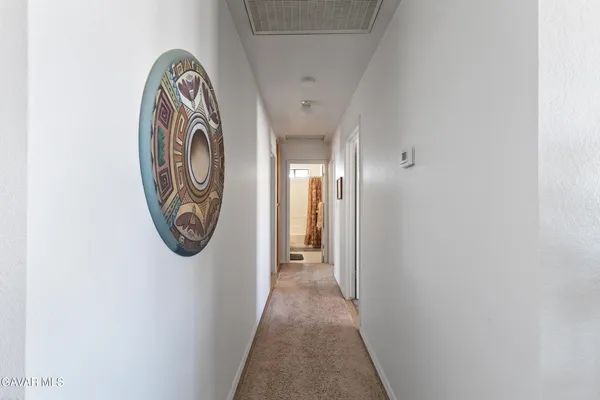 a view of a hallway with bathroom