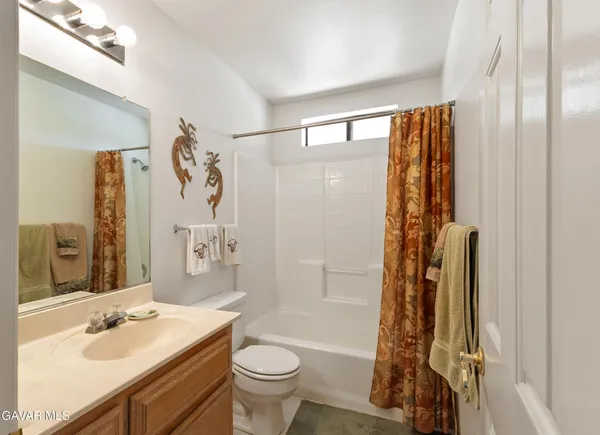 a bathroom with a sink toilet tub and shower