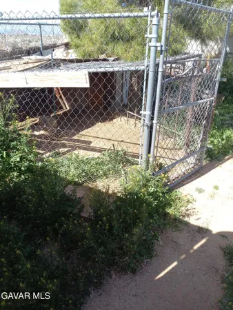 a view of a small yard with wooden fence