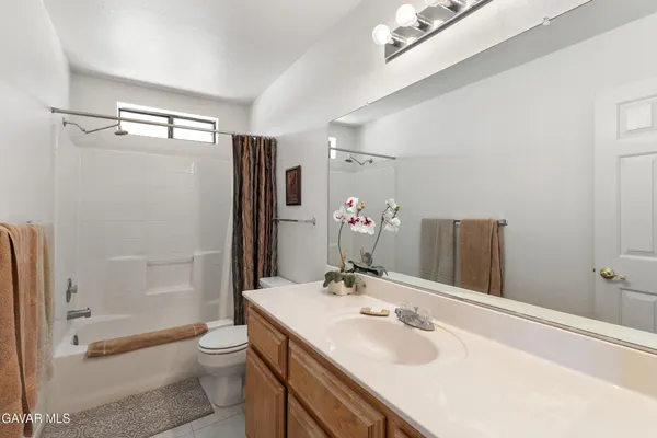 a bathroom with a sink toilet tub and shower
