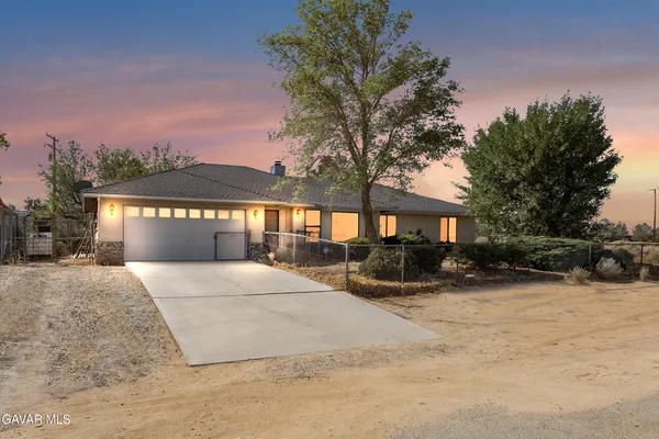 a view of a house with a yard covered with snow in the outdoor space