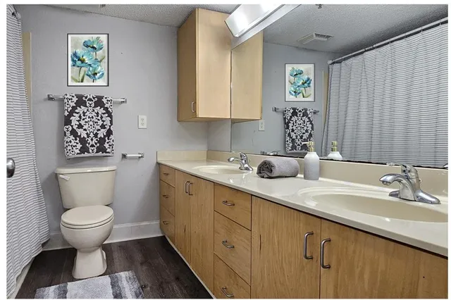 a bathroom with a toilet sink and mirror