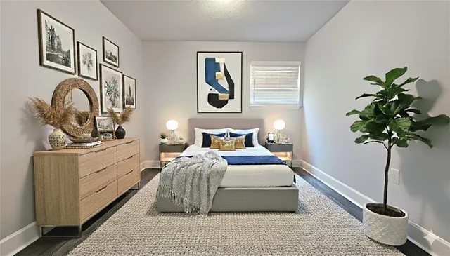 a bedroom with bed and a potted plant