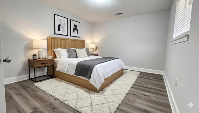 a bedroom with a bed and a night stand