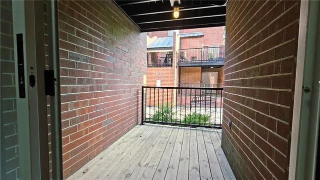 a view of a brick house with a large window