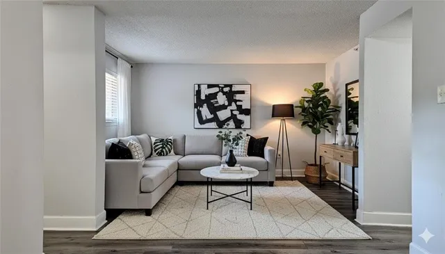 a living room with furniture and wooden floor