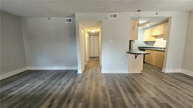 a view of a room with wooden floor and a window