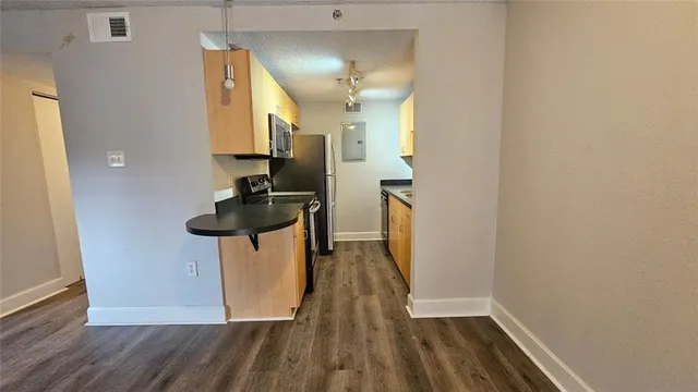 a view of hallway with wooden floor