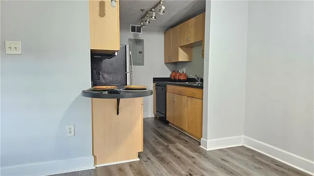 a kitchen with a refrigerator and a stove top oven