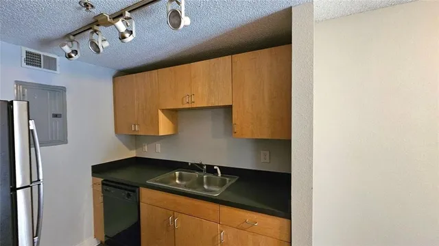 a kitchen with a sink and a refrigerator