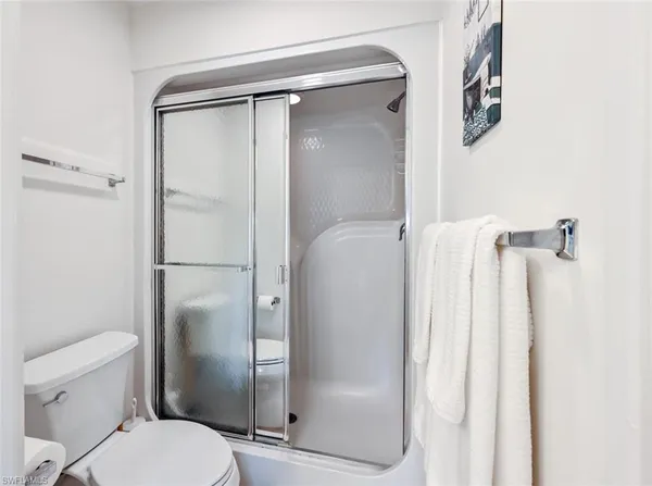 a bathroom with a shower and a toilet