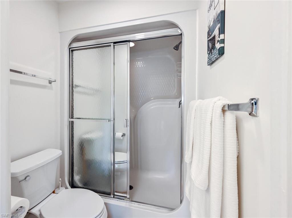515 Gabriel Circle, Unit 1910 Naples, FL 34104 - Photo 12 of 29 a bathroom with a shower and a toilet