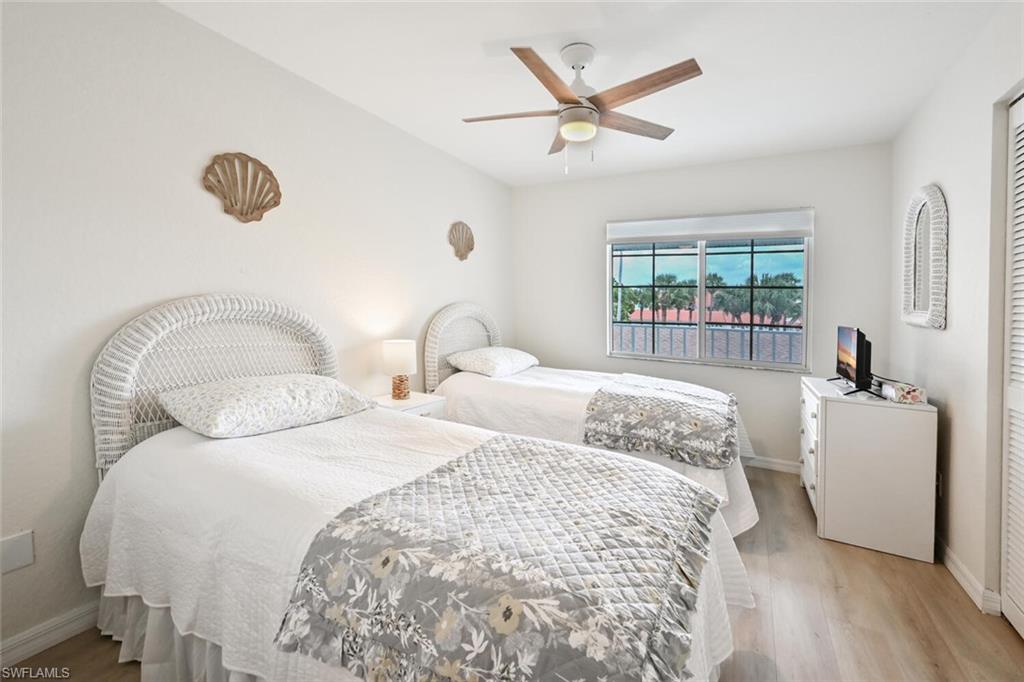 515 Gabriel Circle, Unit 1910 Naples, FL 34104 - Photo 14 of 29 a bedroom with two beds and a window