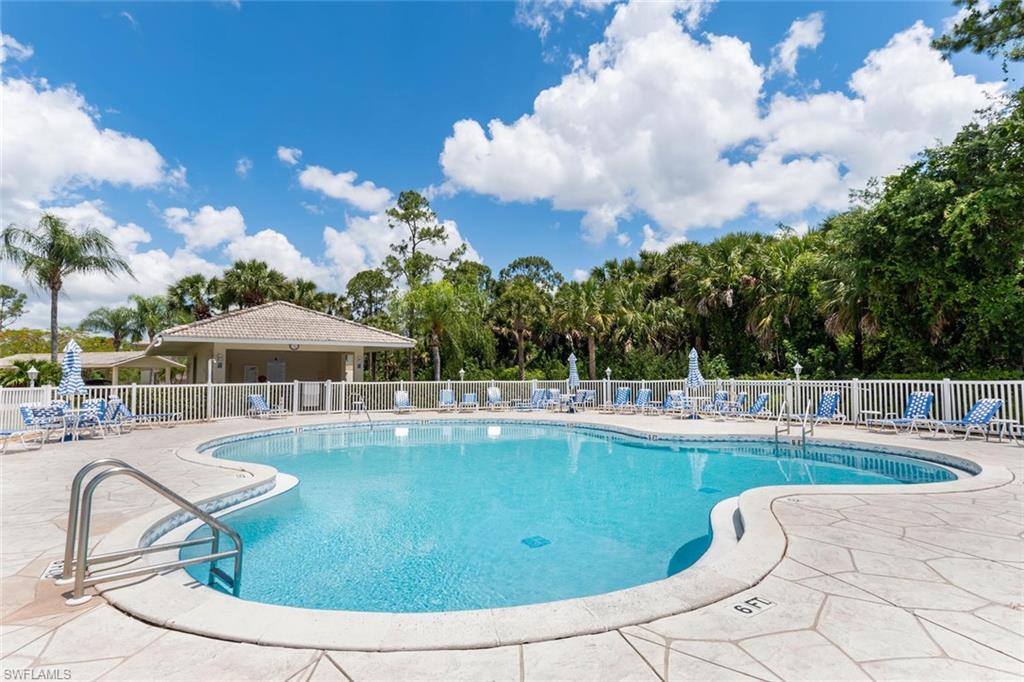 515 Gabriel Circle, Unit 1910 Naples, FL 34104 - Photo 26 of 29 a view of a swimming pool with lounge chair