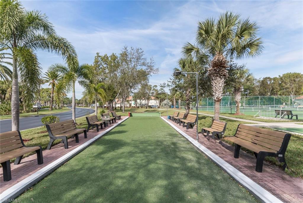 515 Gabriel Circle, Unit 1910 Naples, FL 34104 - Photo 29 of 29 a view of a lake with a deck and a yard