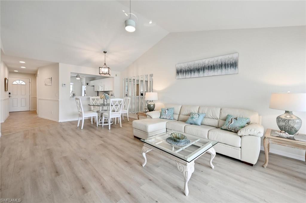 515 Gabriel Circle, Unit 1910 Naples, FL 34104 - Photo 4 of 29 a living room with furniture and a wooden floor