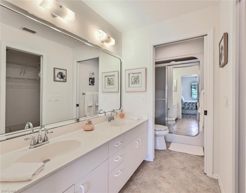 515 Gabriel Circle, Unit 1910 Naples, FL 34104 - Photo 6 of 29 a spacious bathroom with a double vanity sink mirror and toilet