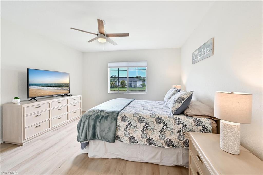 515 Gabriel Circle, Unit 1910 Naples, FL 34104 - Photo 7 of 29 a bedroom with a bed and a flat screen tv