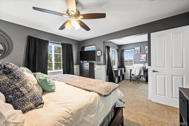 a bedroom with a bed and ceiling fan