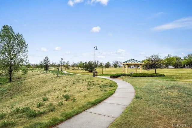 a view of a town with swimming pool and trees
