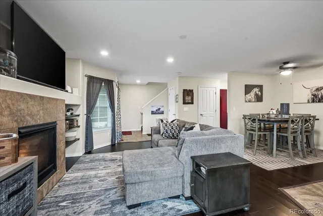 a living room with furniture a flat screen tv and a fireplace
