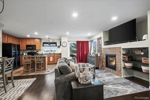 a living room with furniture a flat screen tv and a fireplace