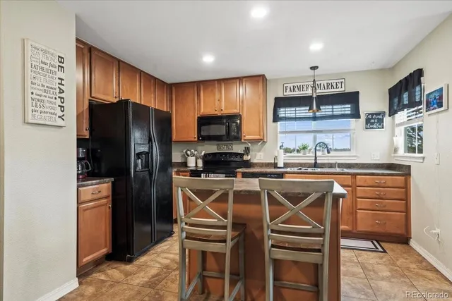 a kitchen with stainless steel appliances a refrigerator stove microwave and cabinets