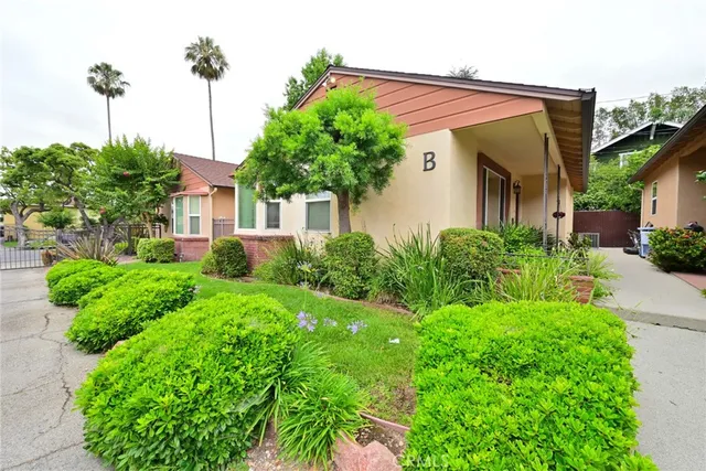 a view of a garden with a house