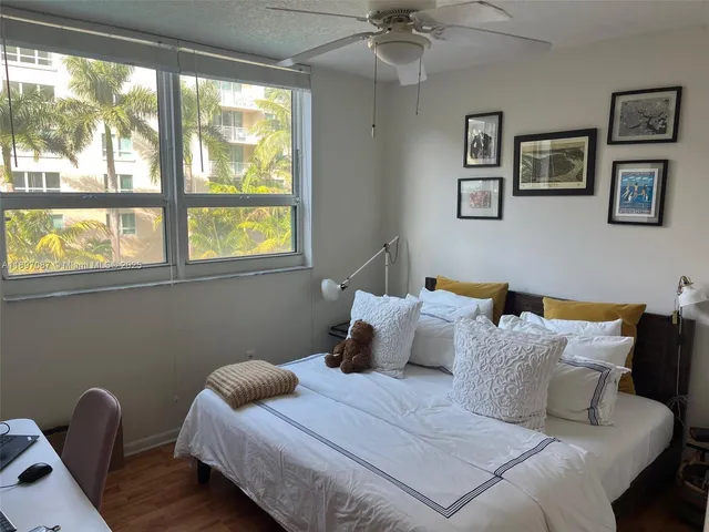 a bedroom with bed and a window