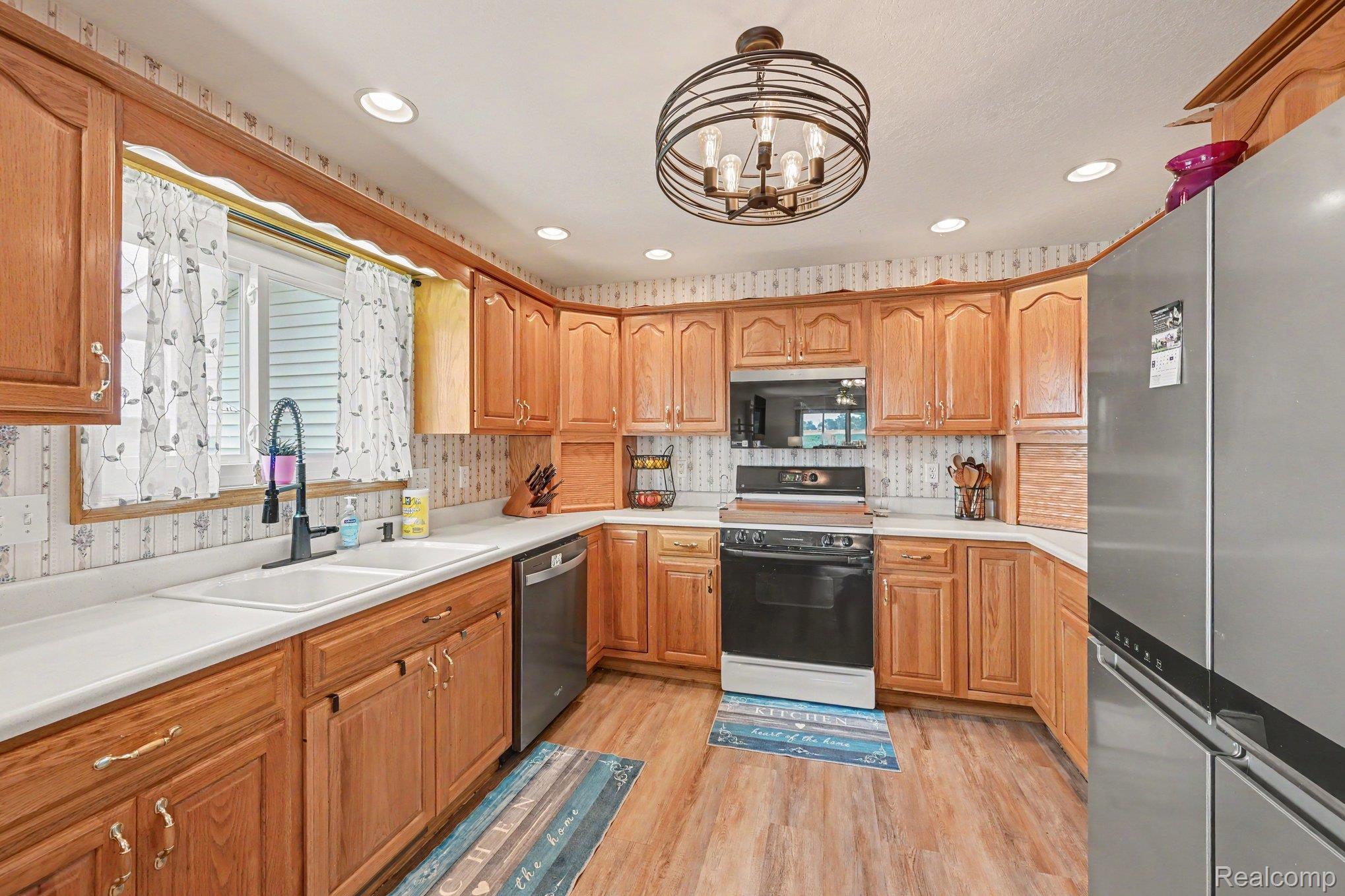 996 Arbogast Road Union City, MI 49094 - Photo 11 of 34 Kitchen featuring wood-finish cabinetry, white countertops, and wood-finish flooring
