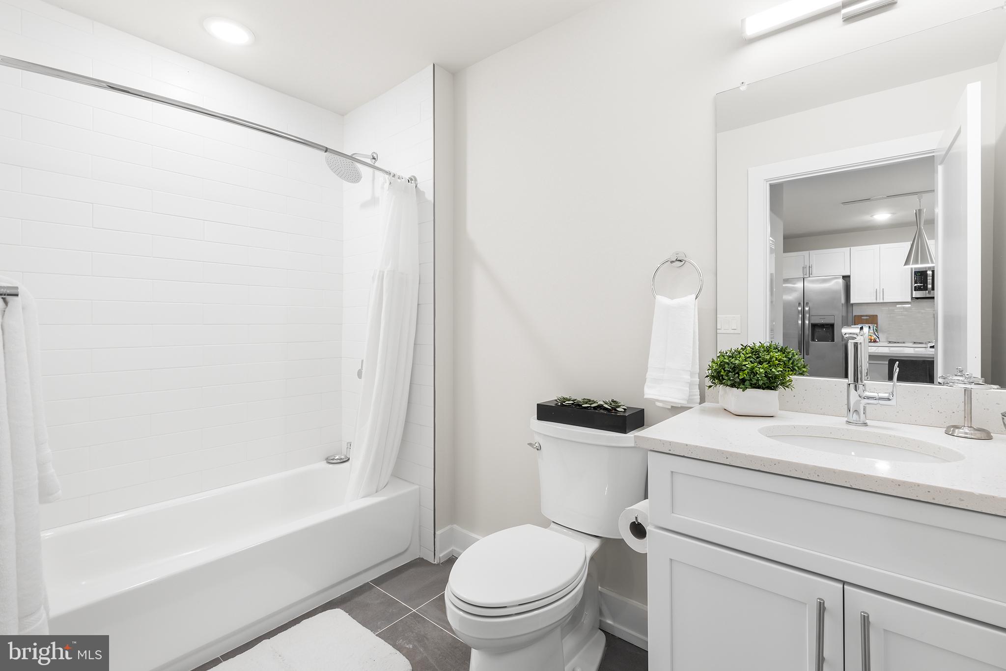 214 Vine Street, Unit 604 Philadelphia, PA 19106 - Photo 14 of 35 a bathroom with a sink toilet and shower