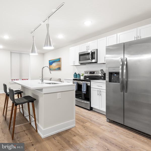 214 Vine Street, Unit 604 Philadelphia, PA 19106 - Photo 2 of 35 a kitchen with a sink stainless steel appliances and cabinets