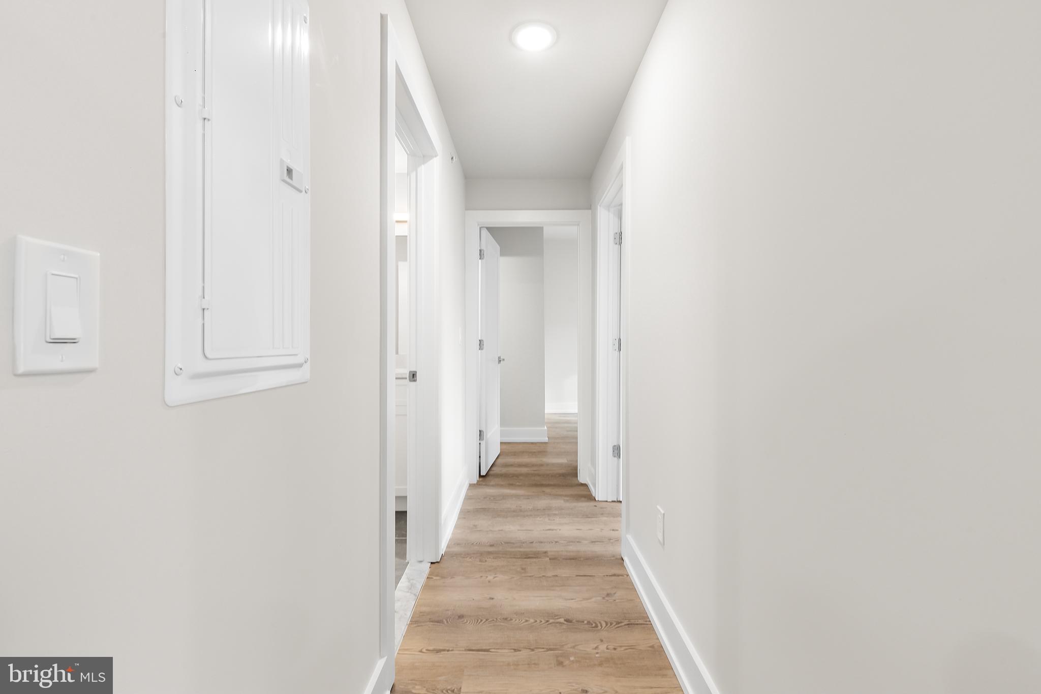 214 Vine Street, Unit 604 Philadelphia, PA 19106 - Photo 27 of 35 a view of a hallway with wooden floor and staircase