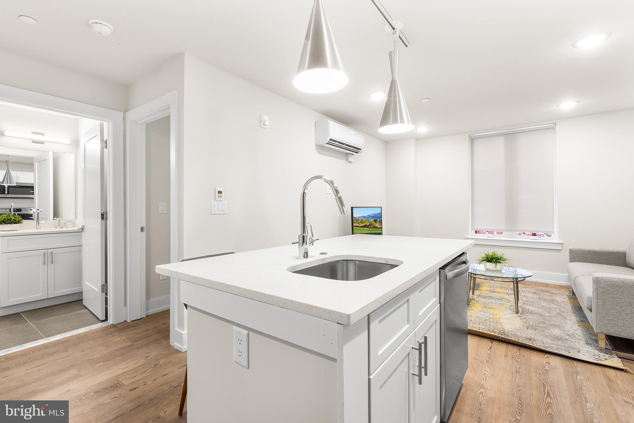 214 Vine Street, Unit 604 Philadelphia, PA 19106 - Photo 8 of 35 a kitchen with a sink and a refrigerator