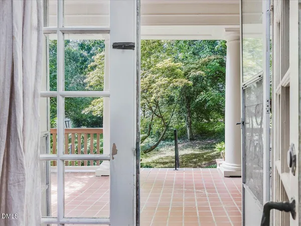 a view of a room with wooden floor and outdoor space